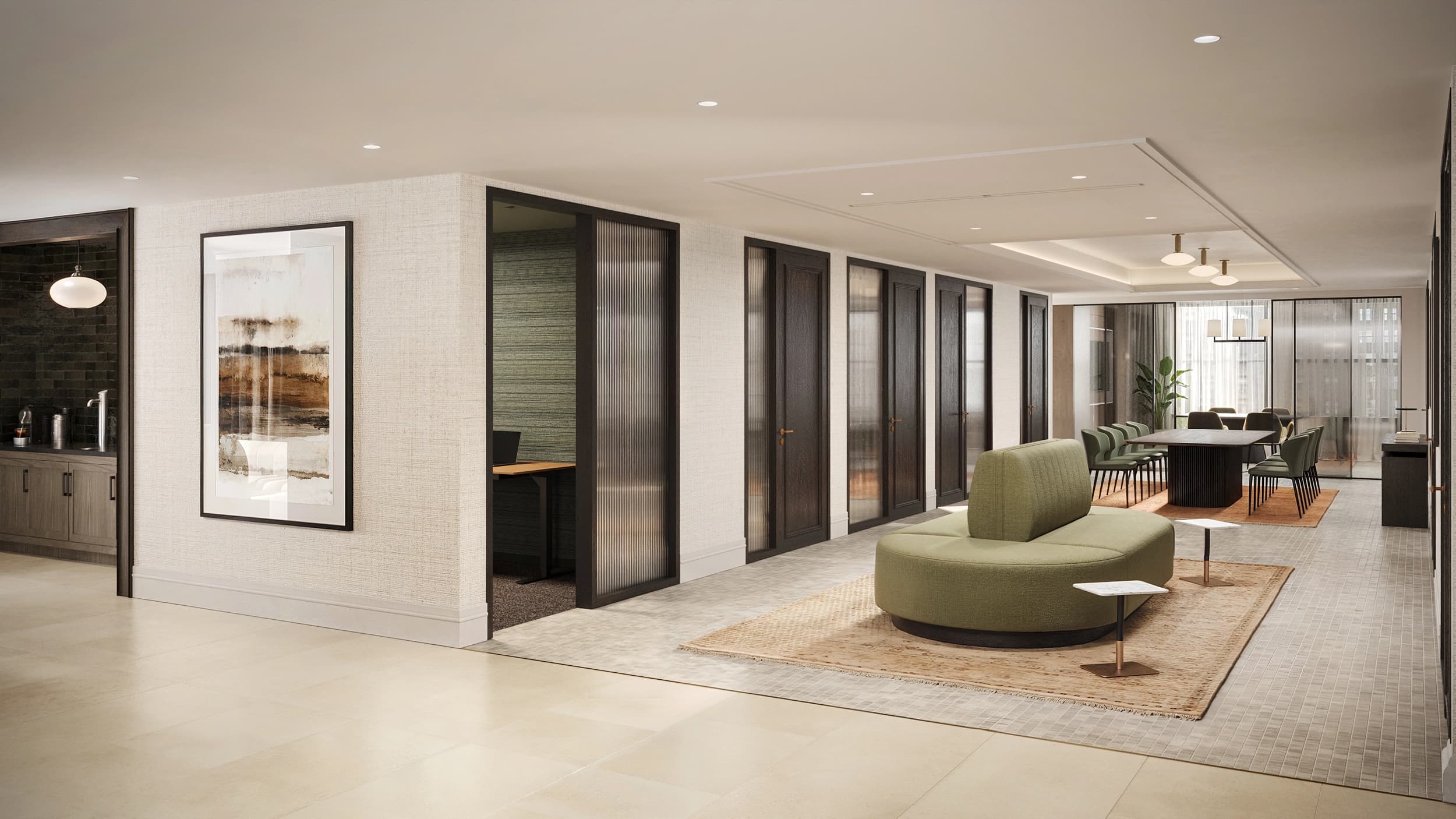 Open common area with curved green seating, framed artwork, black-framed glass partitions, and recessed lighting.
