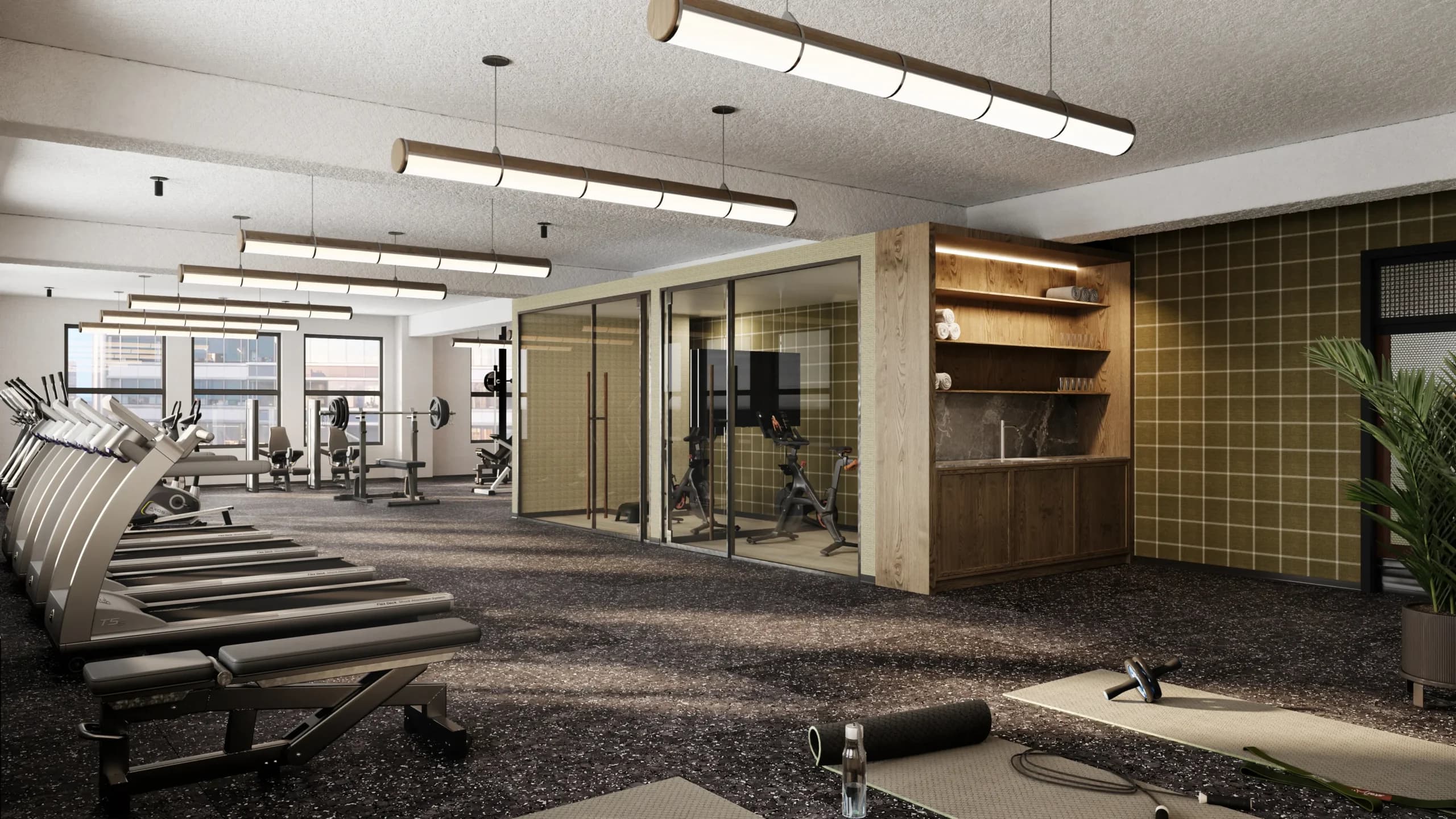Modern fitness center with treadmills and exercise equipment, glass-walled studios, wooden shelving, and olive-toned tile accent wall.