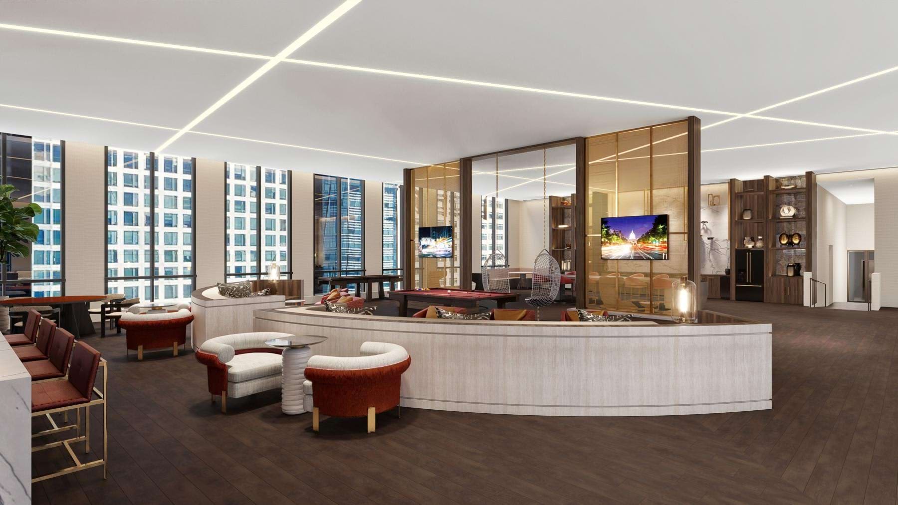 Modern lobby with curved white reception desk, burgundy seating, linear ceiling lights, and floor-to-ceiling windows overlooking city buildings.