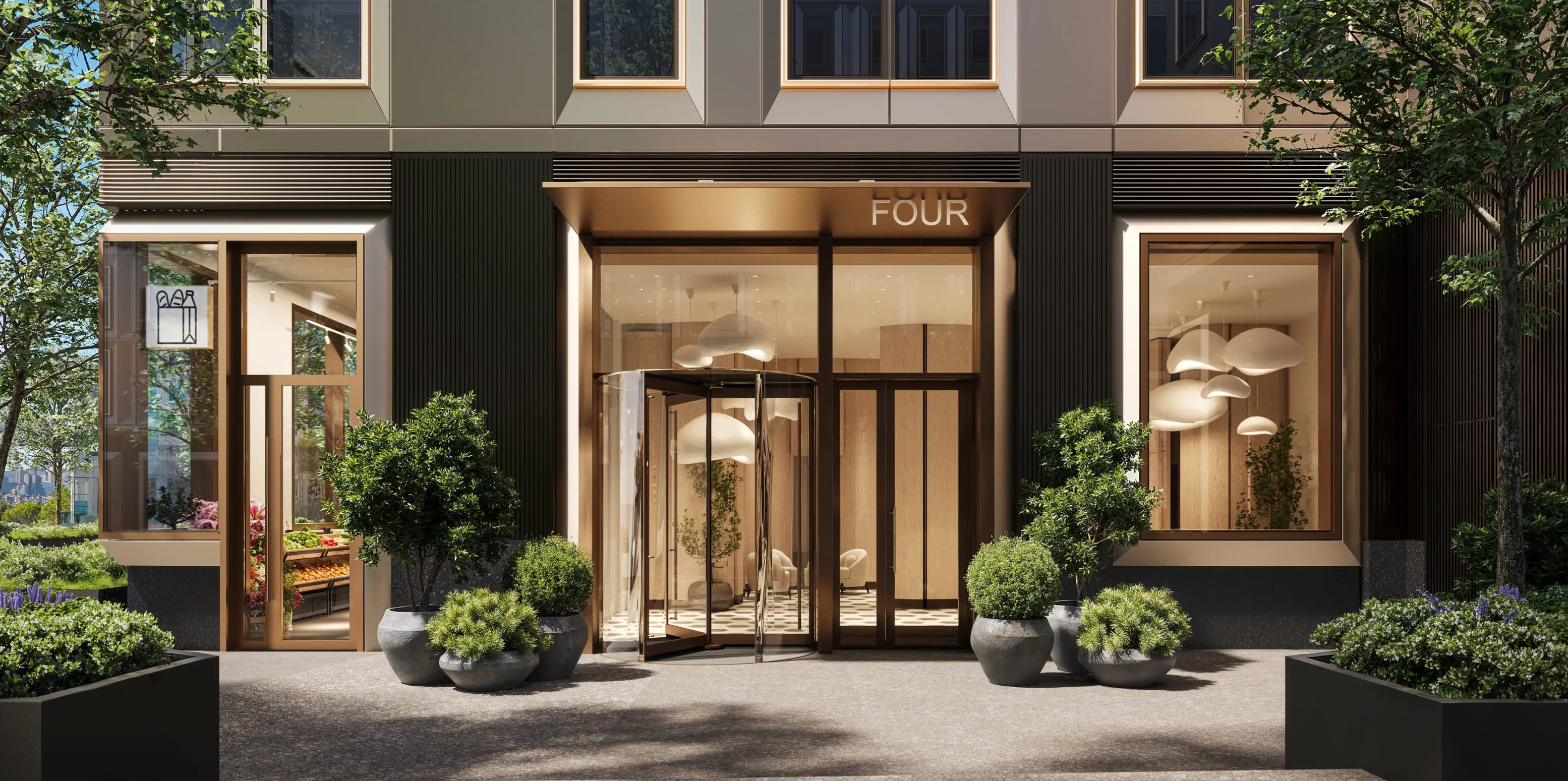 Modern building entrance with glass doors, wood framing, potted plants, and contemporary facade in neutral tones.