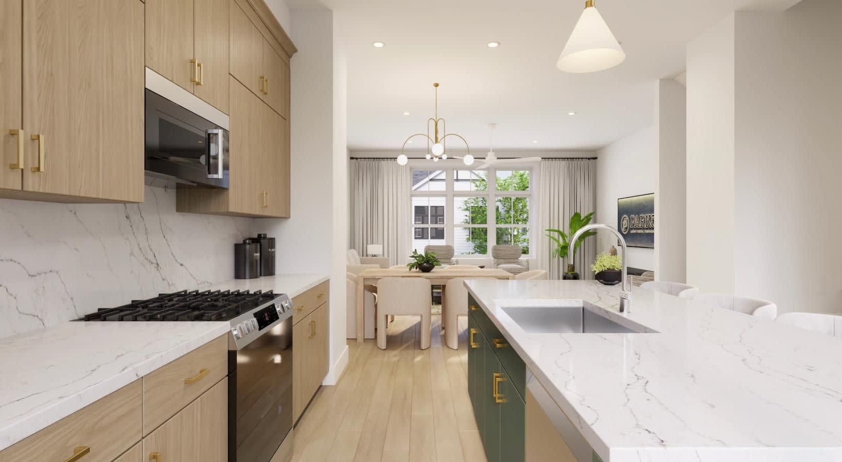 Contemporary kitchen with light wood cabinets, white marble countertops, gas range, and island with sink overlooking dining space with large windows.