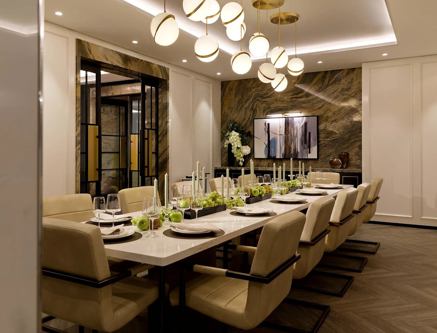 Formal dining room with long white table, eight beige upholstered chairs, marble feature wall, and brass pendant lights.