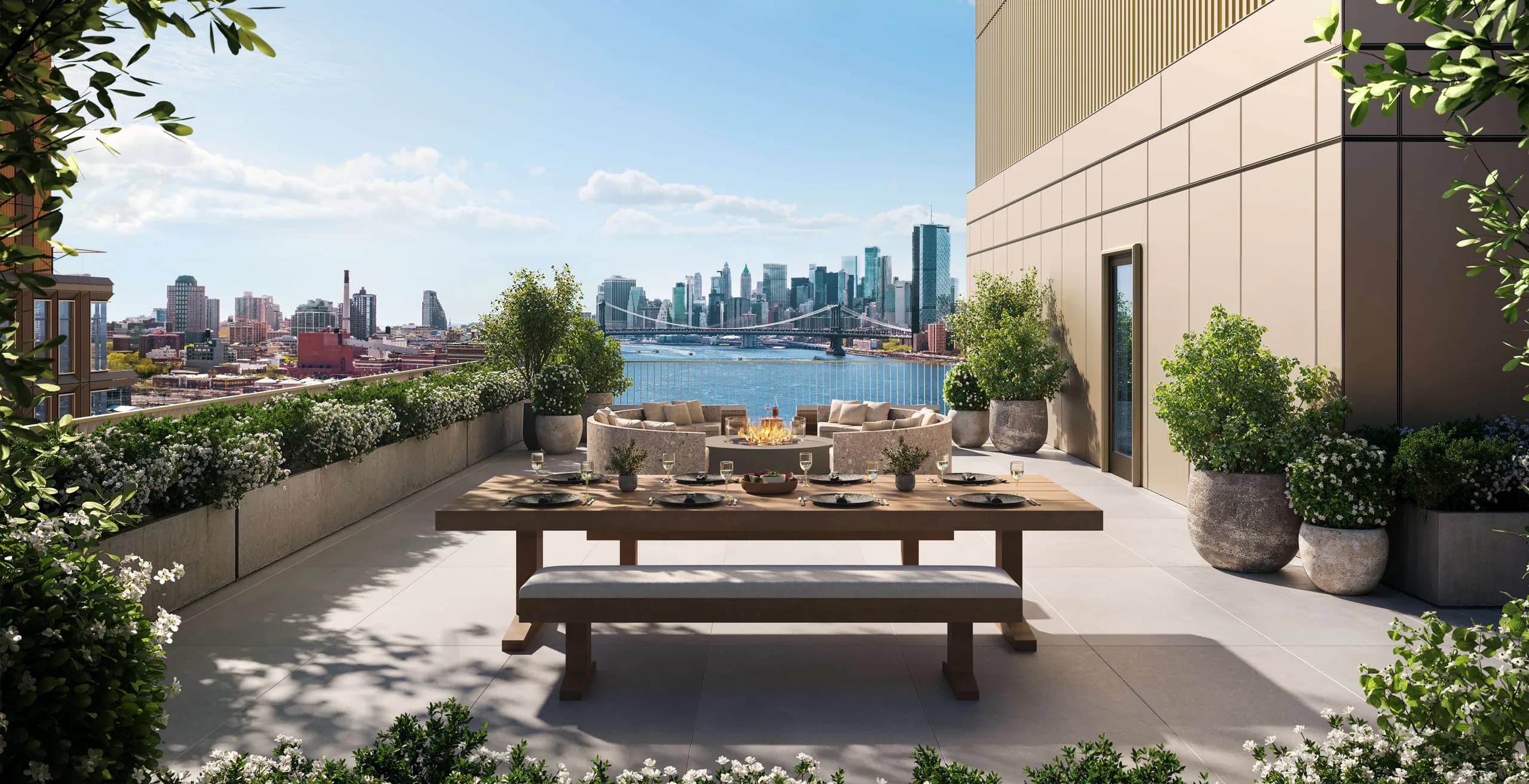 Rooftop terrace with wooden dining table, seating, potted plants, and panoramic views of Manhattan skyline and East River.