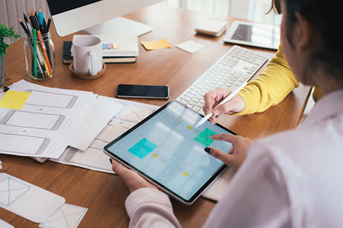 People working on creative mockups | HEXAS Web Design & Softawre Development