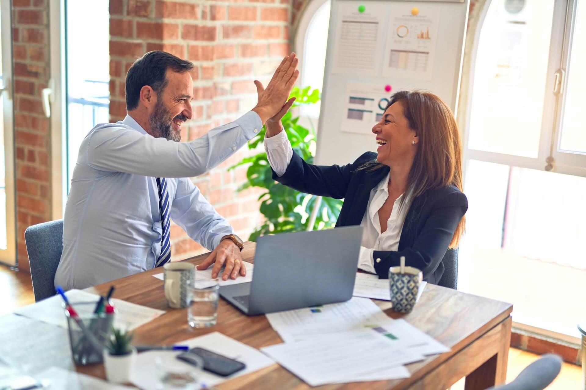 Man and woman celebrating a business deal