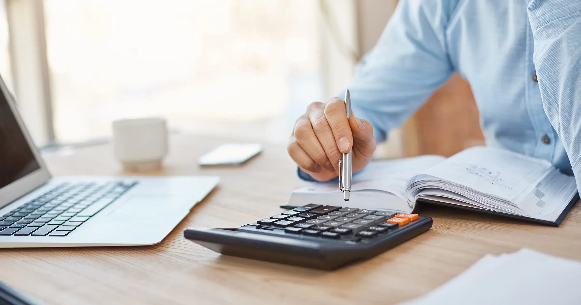 Person at a desk using a calculator