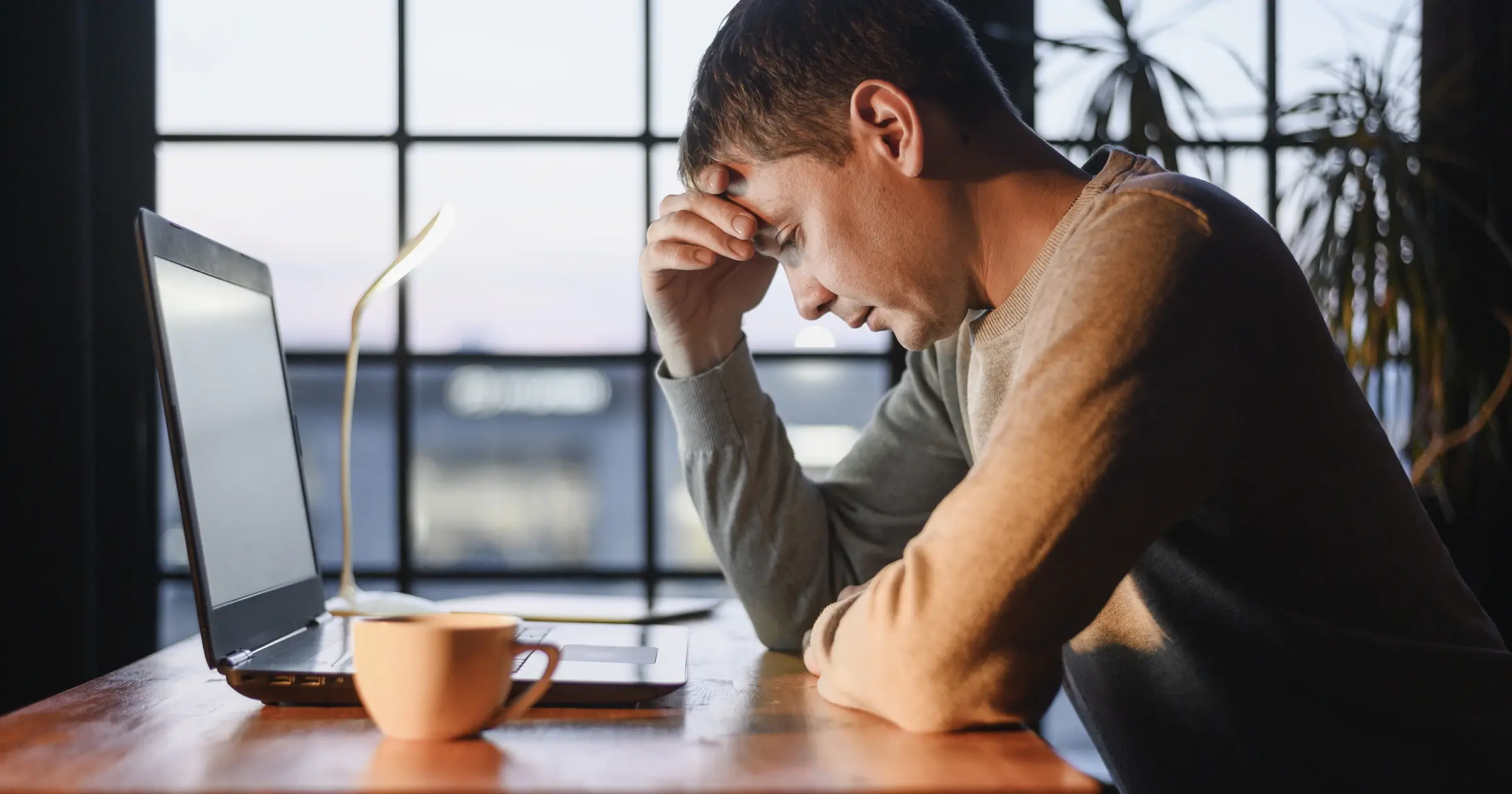 Tired worker at his laptop