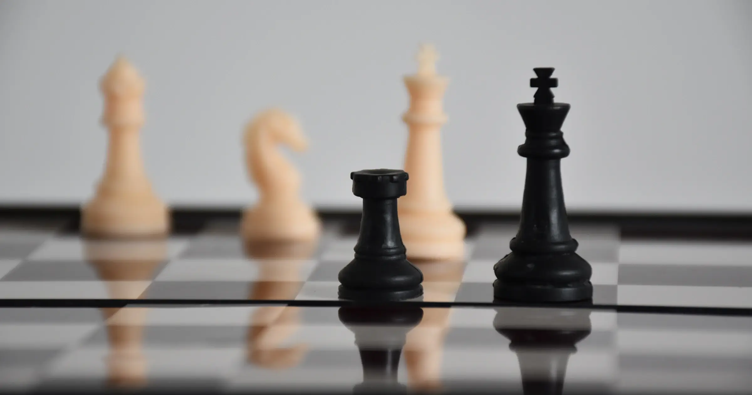 Black and white chess pieces on a board