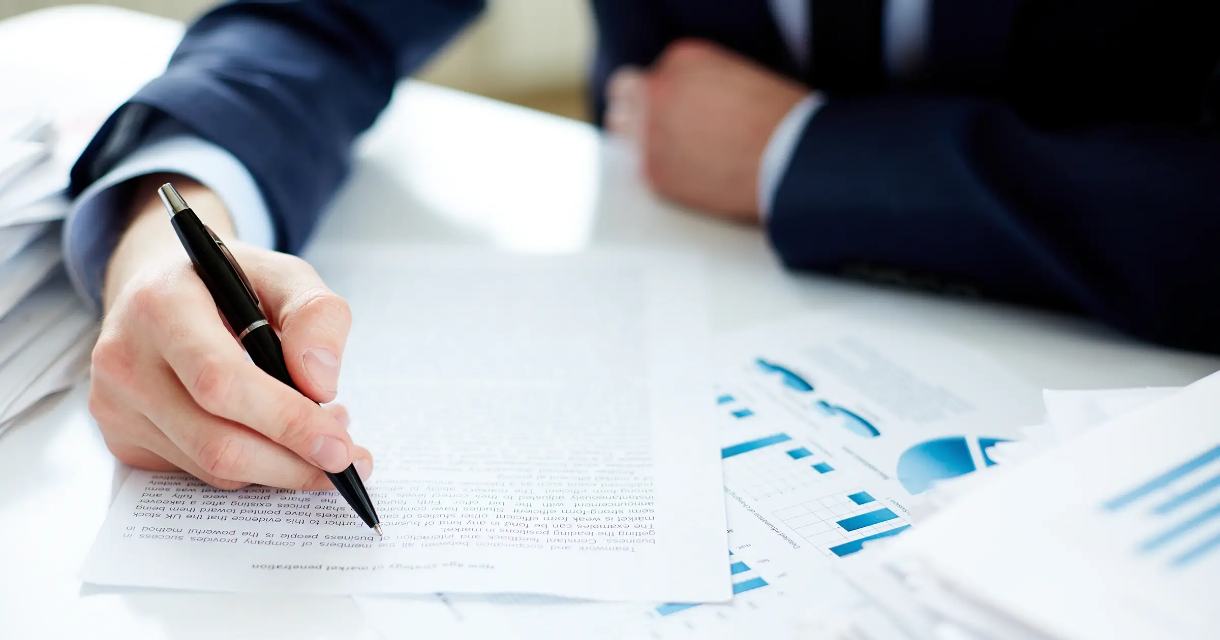 Businessman underlining words on a page