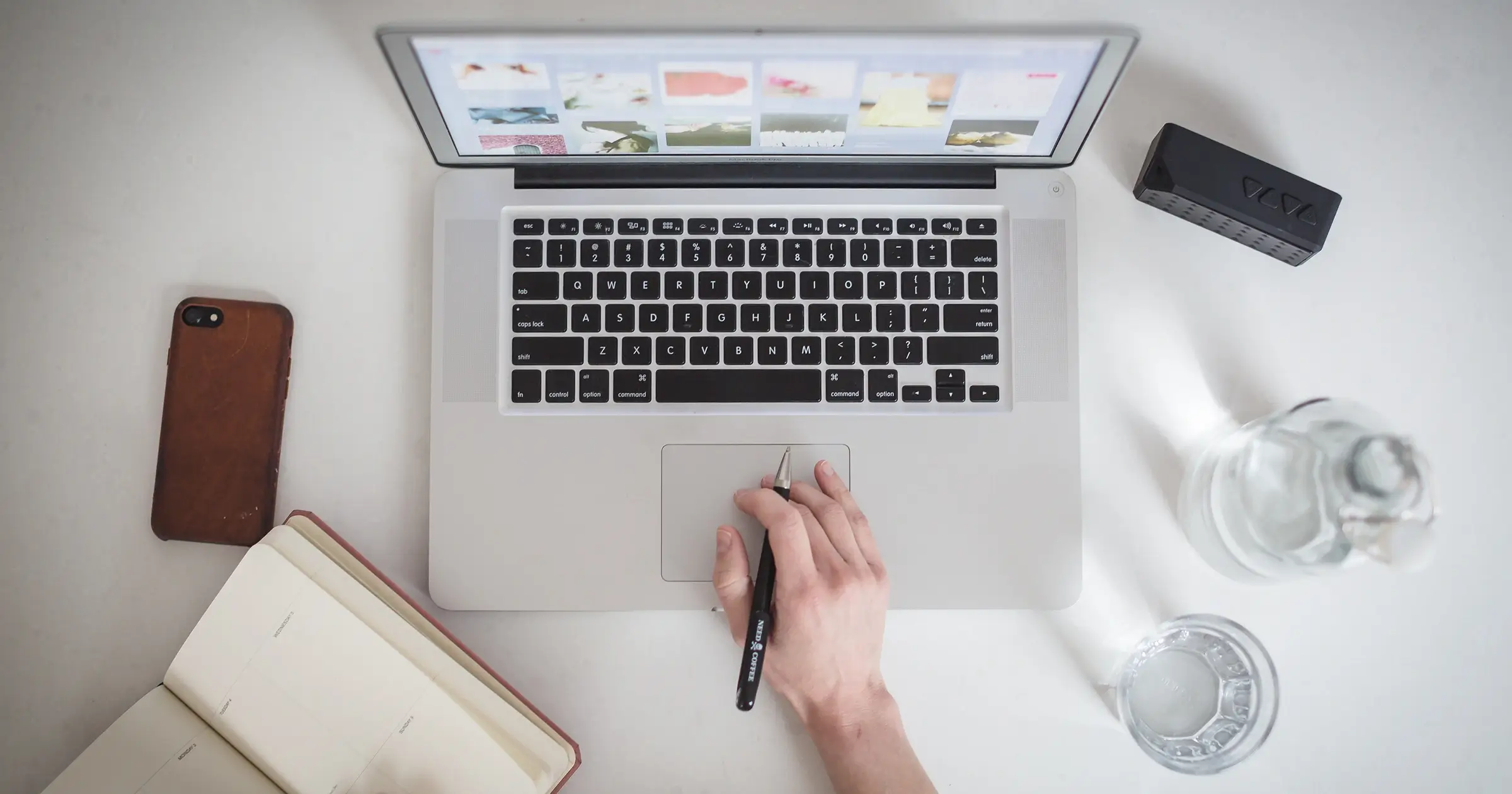 Aerial shot of a hand and a laptop