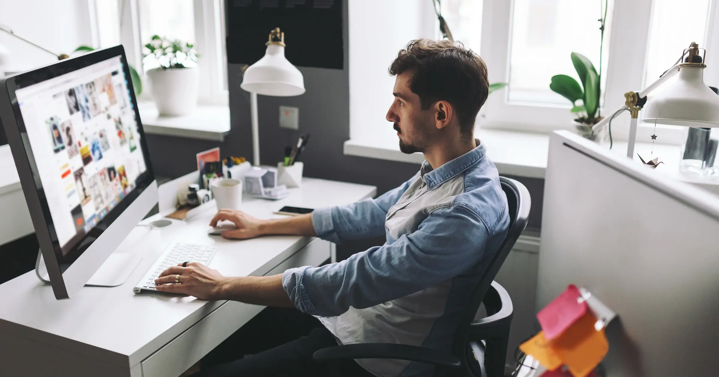 Web designer working on a desktop computer