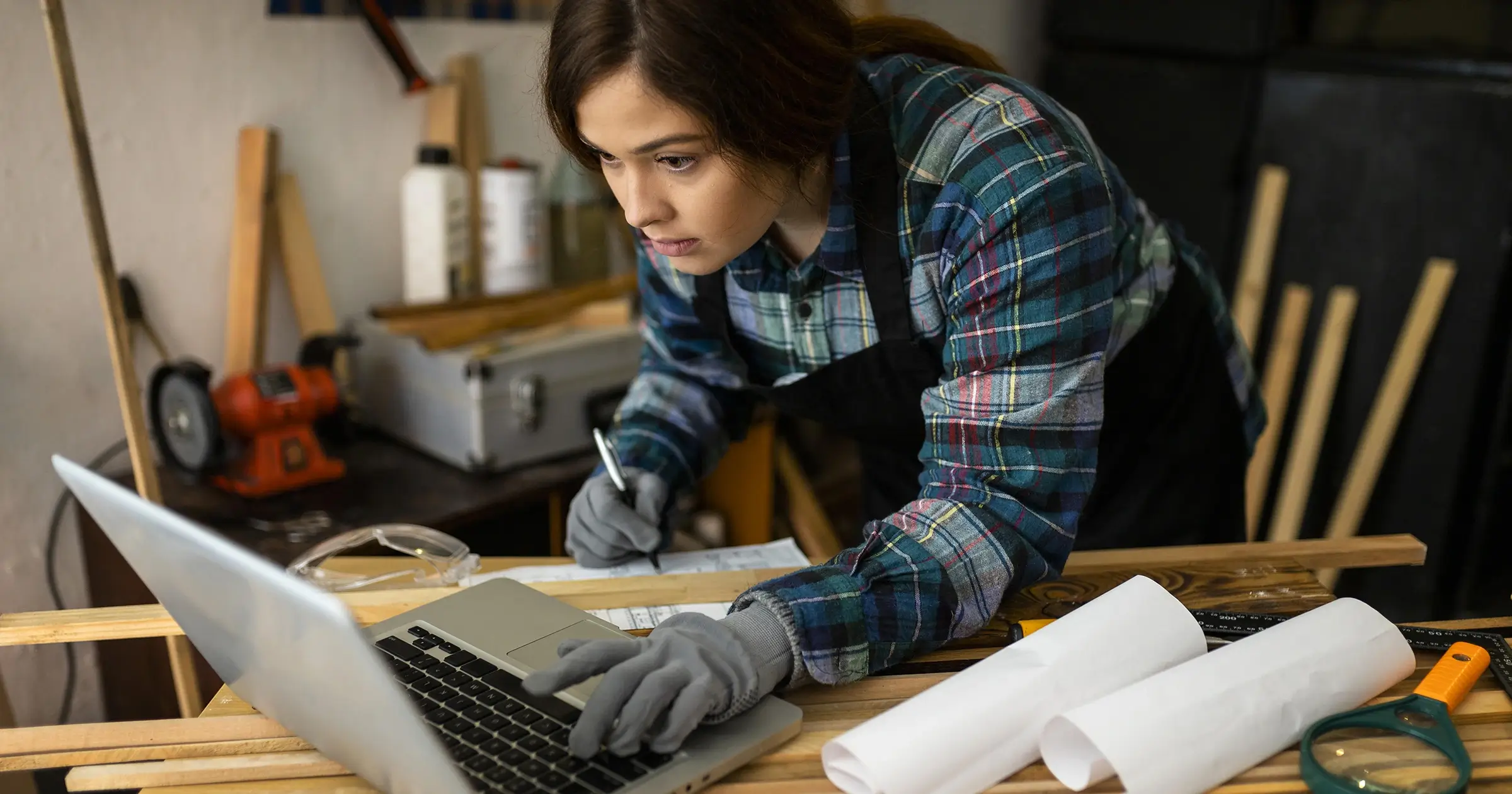 Woman using a laptop in a craft workshop