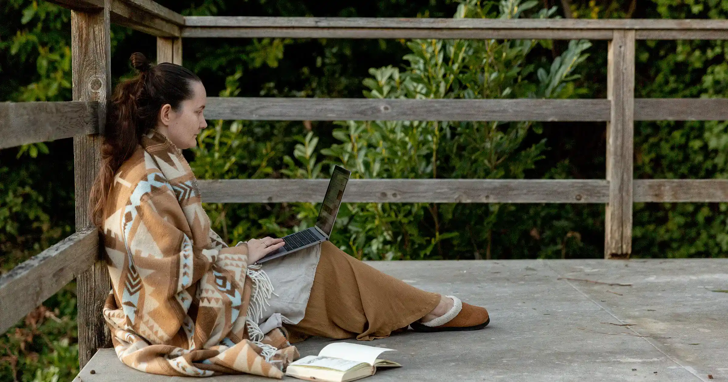 Woman working with her laptop outside