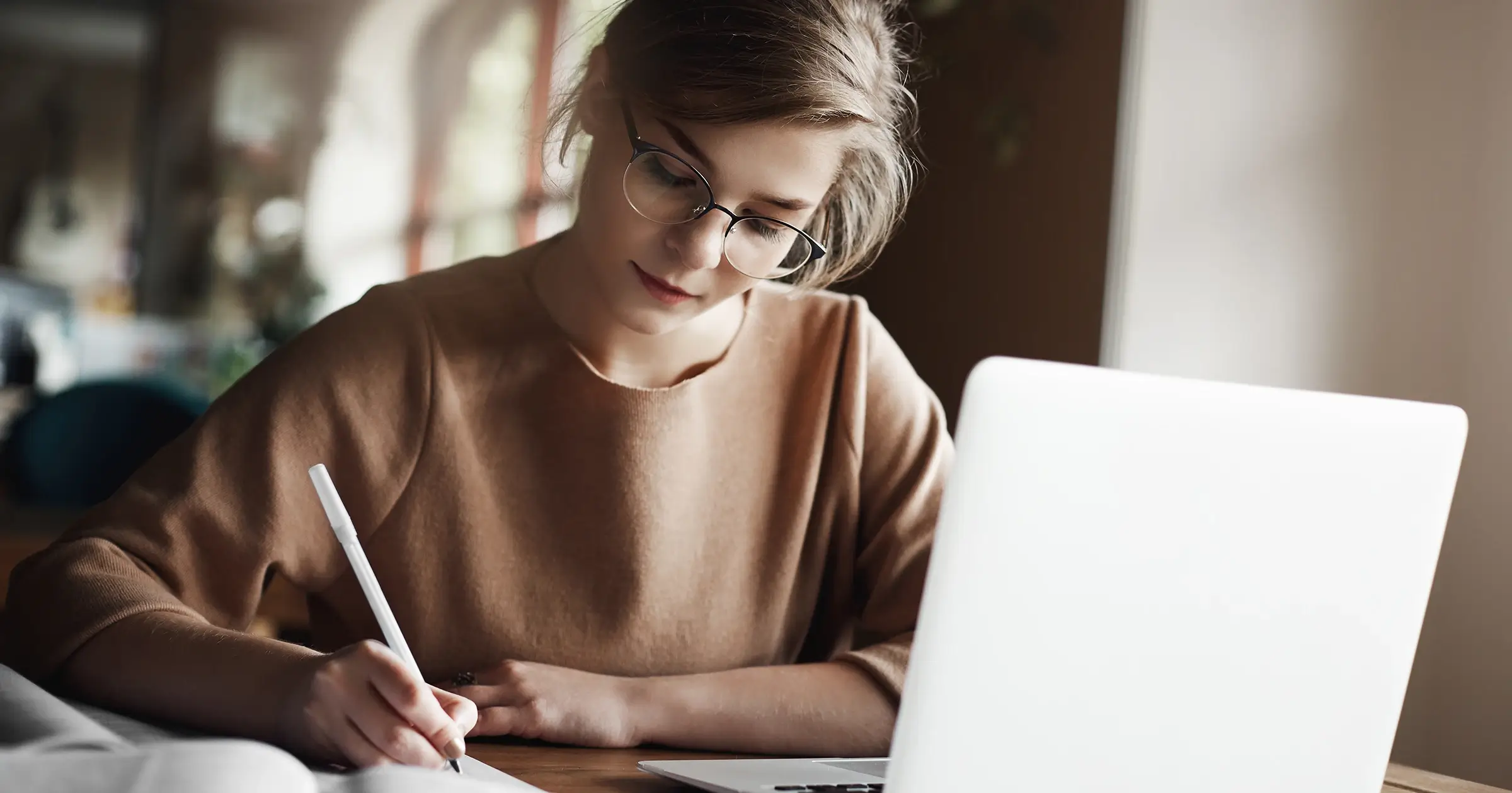 Freelancer writing in front of her laptop