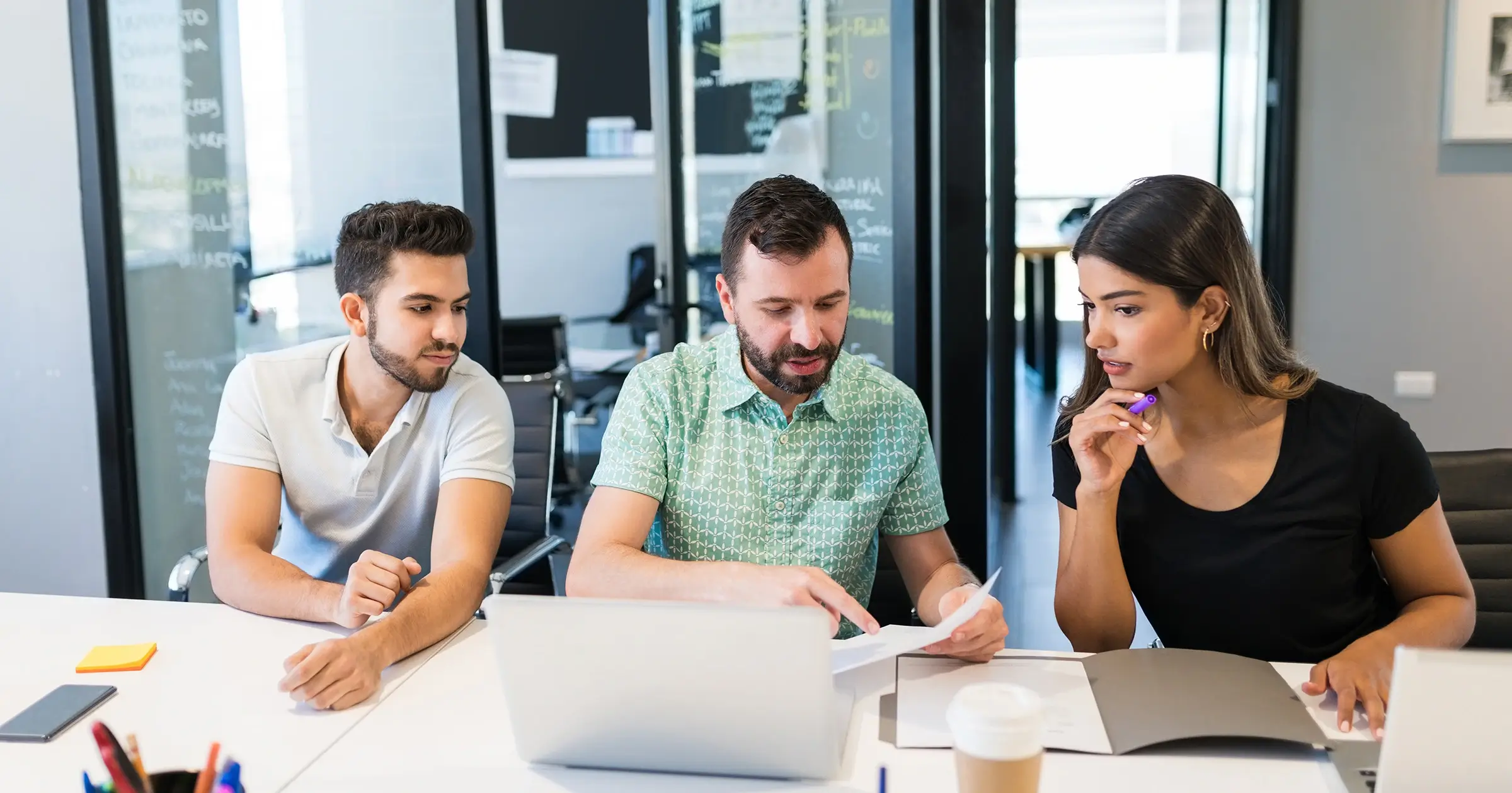 Businessman coaching two team members