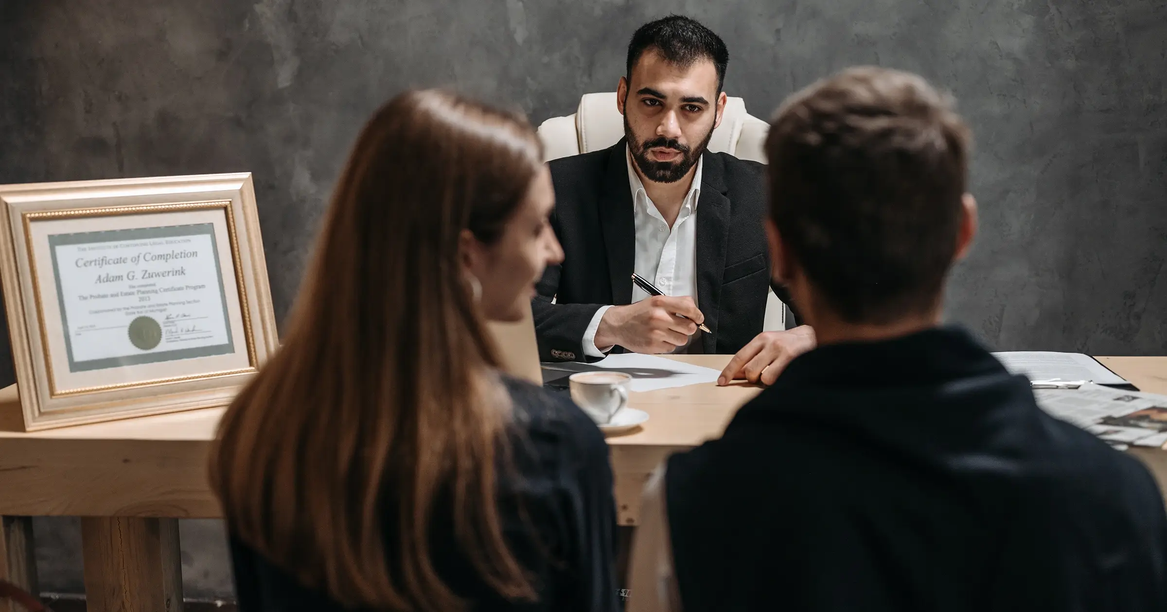 Man talking to a couple at a desk