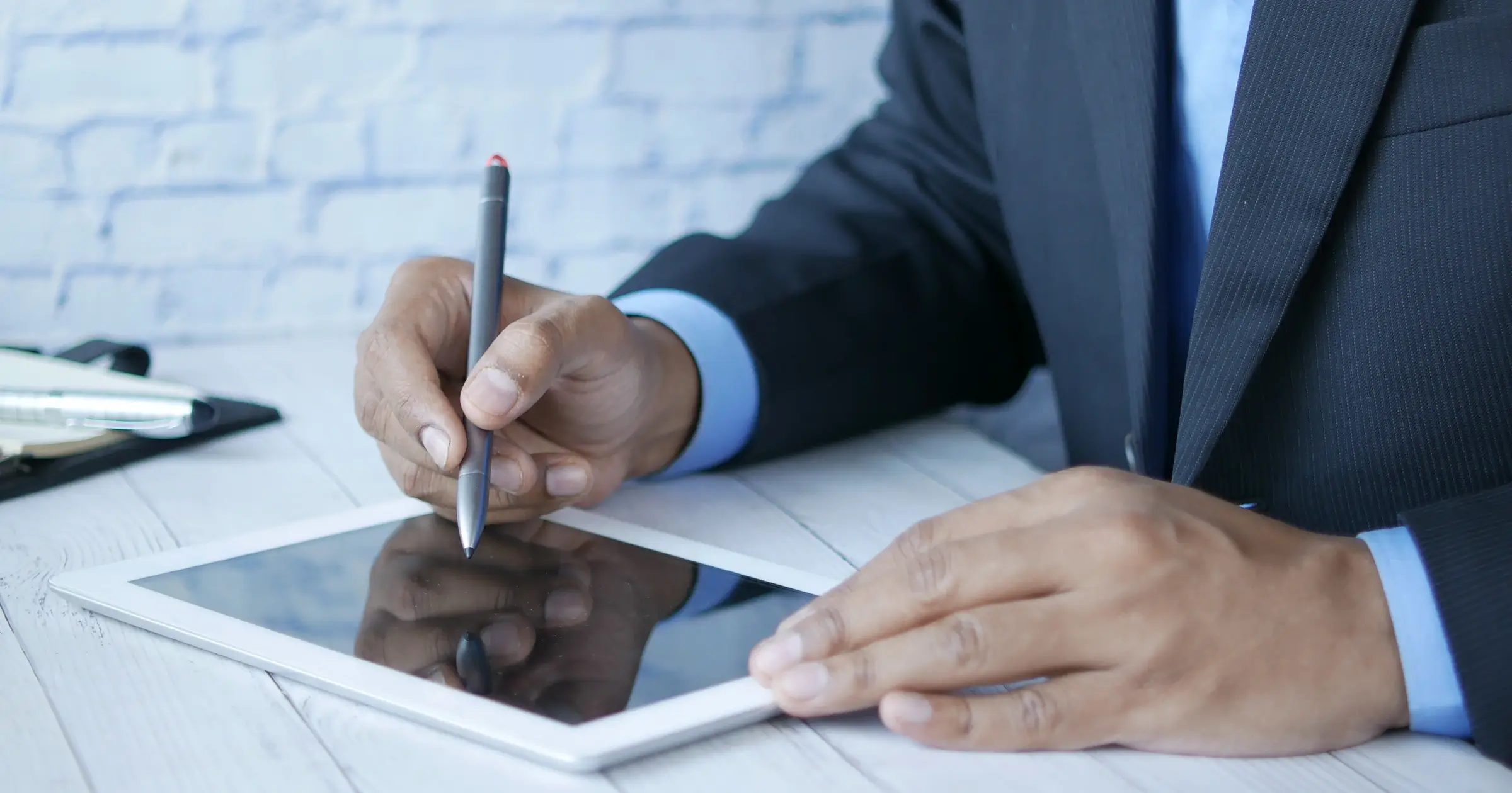 Man making an e-signature on a tablet