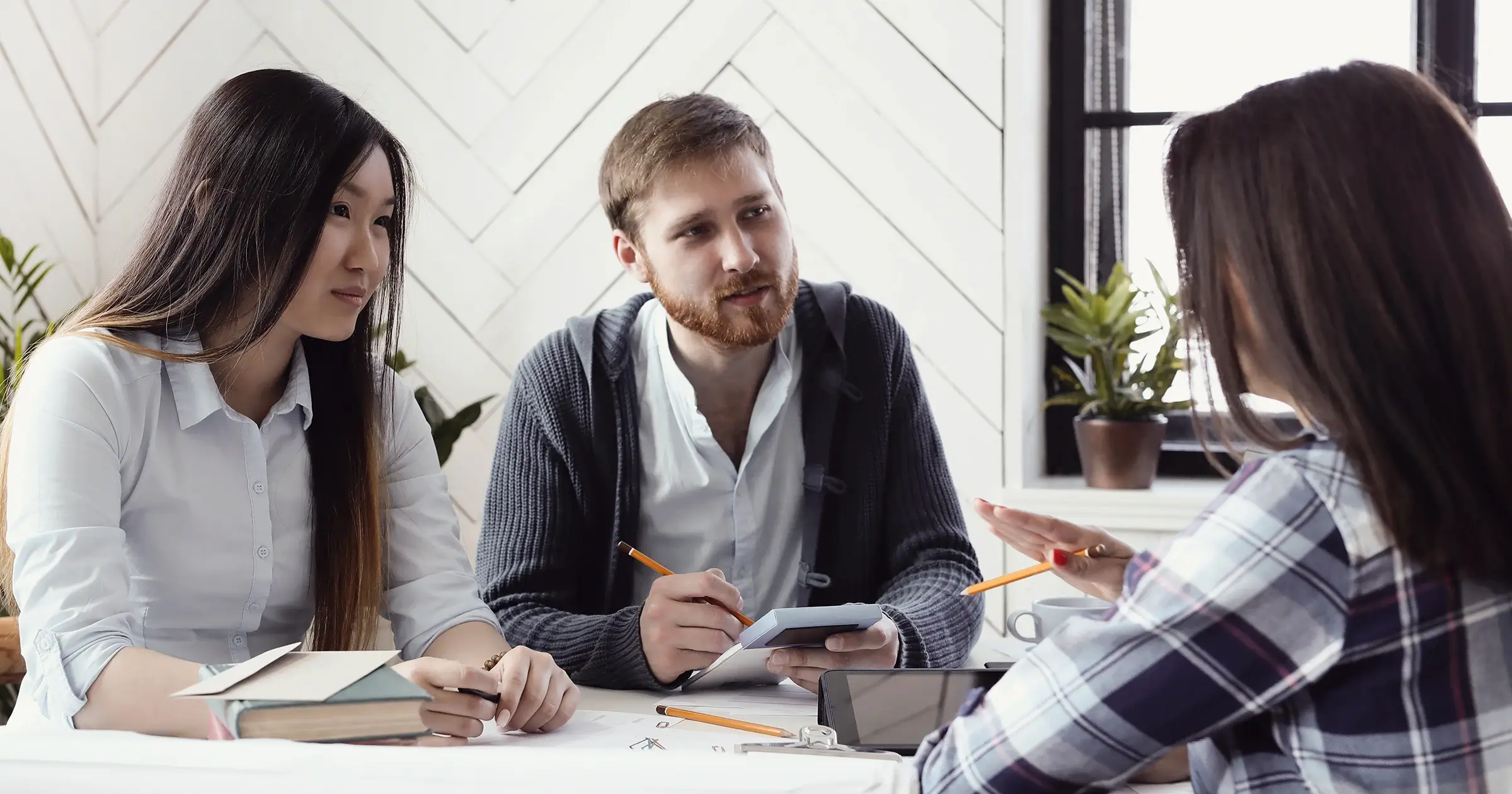 Person in a business meeting facing two other people