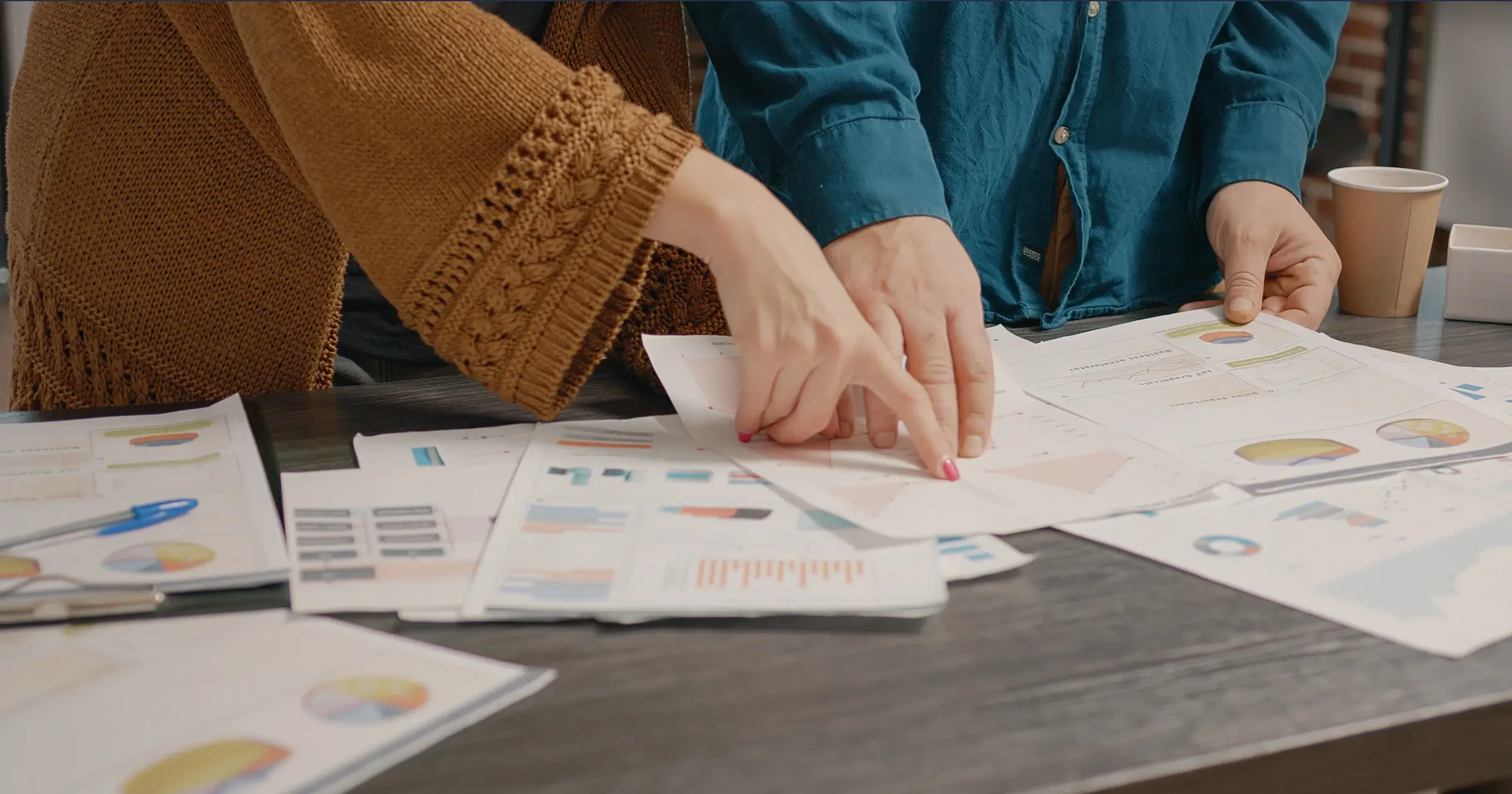 Two people reviewing proposals together