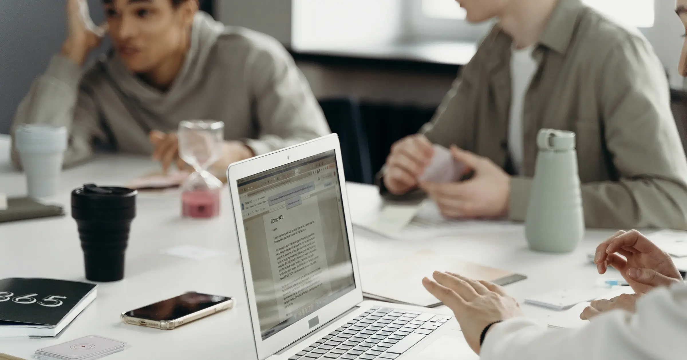 Work desk with several people around it