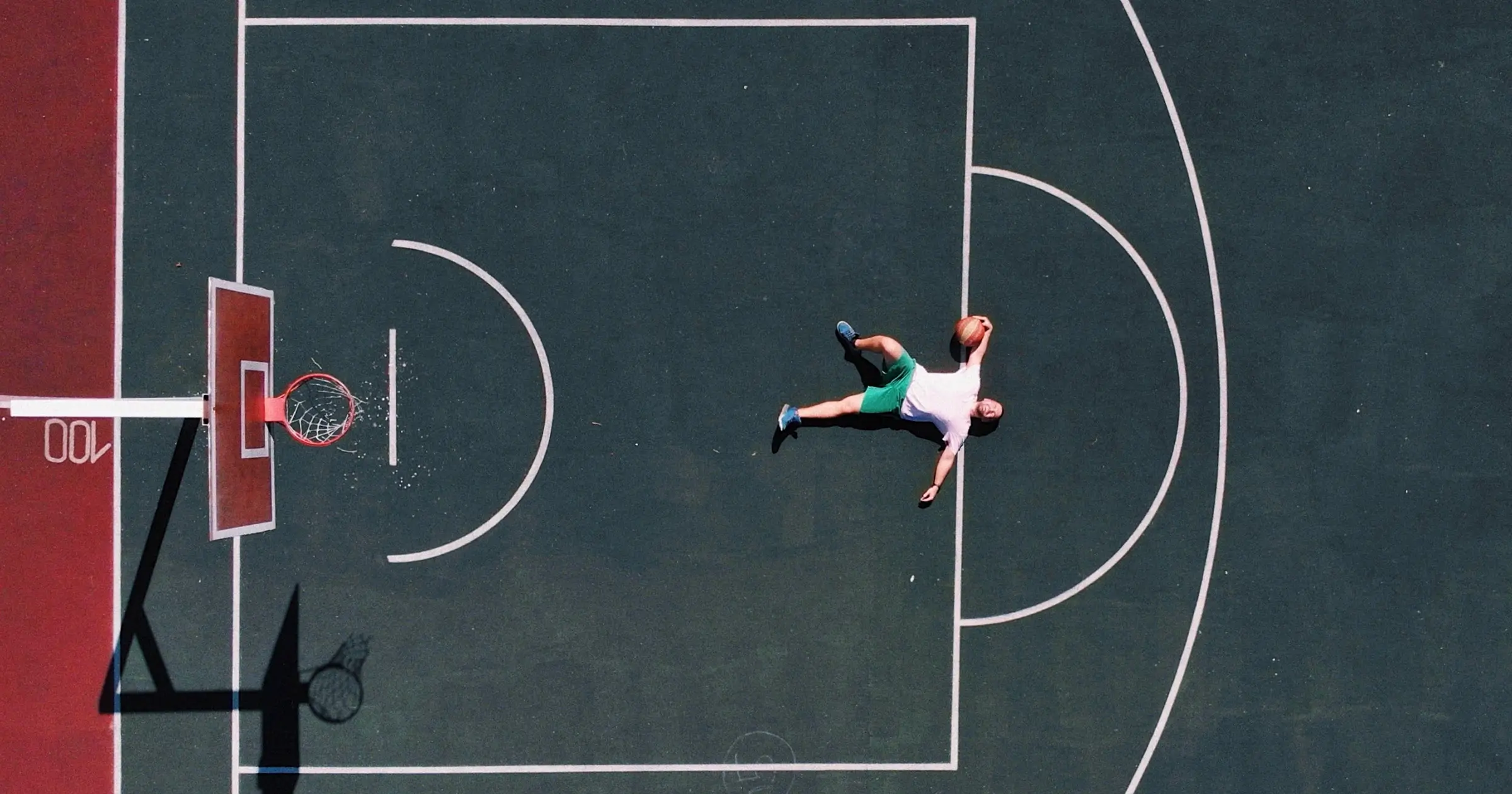 Man lying on his back on a basktball court