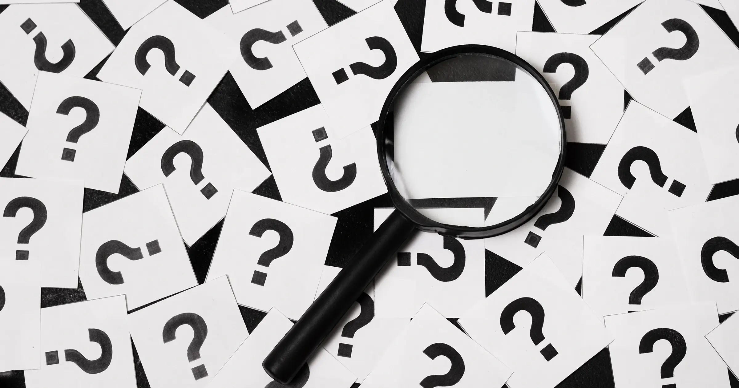 Magnifying glass with question marks