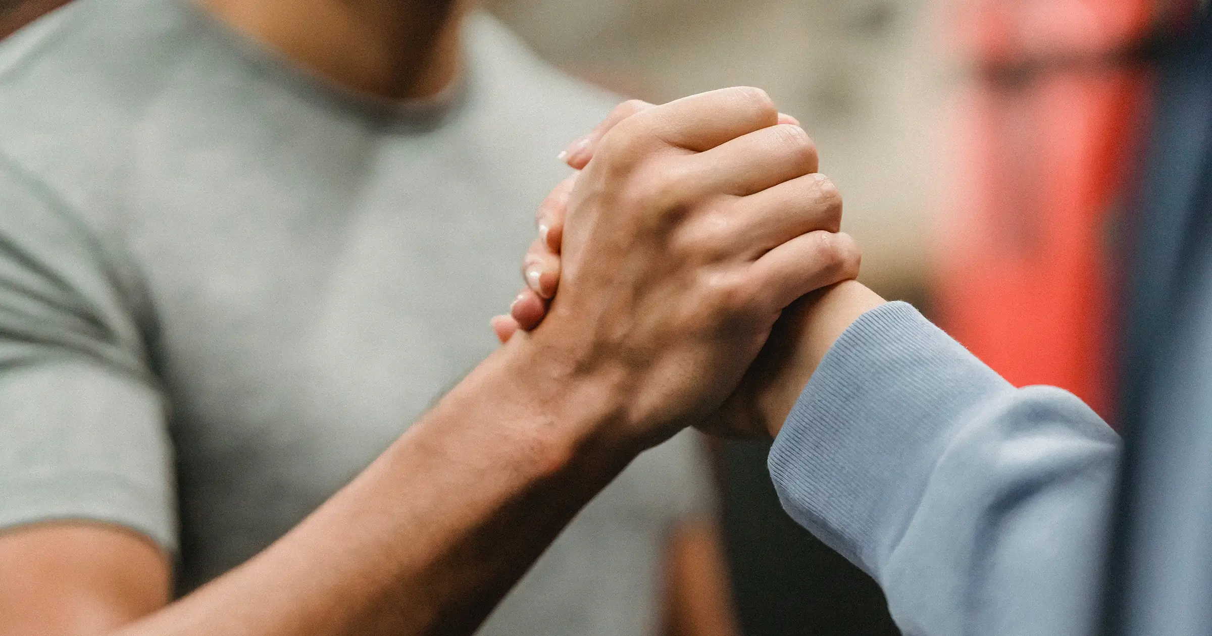 Two people clasping hands together