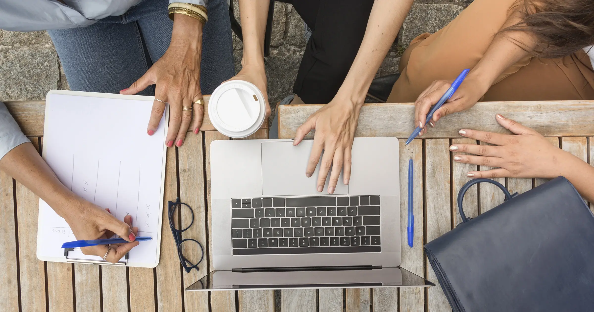 Aerial shot of 3 people at a laptop