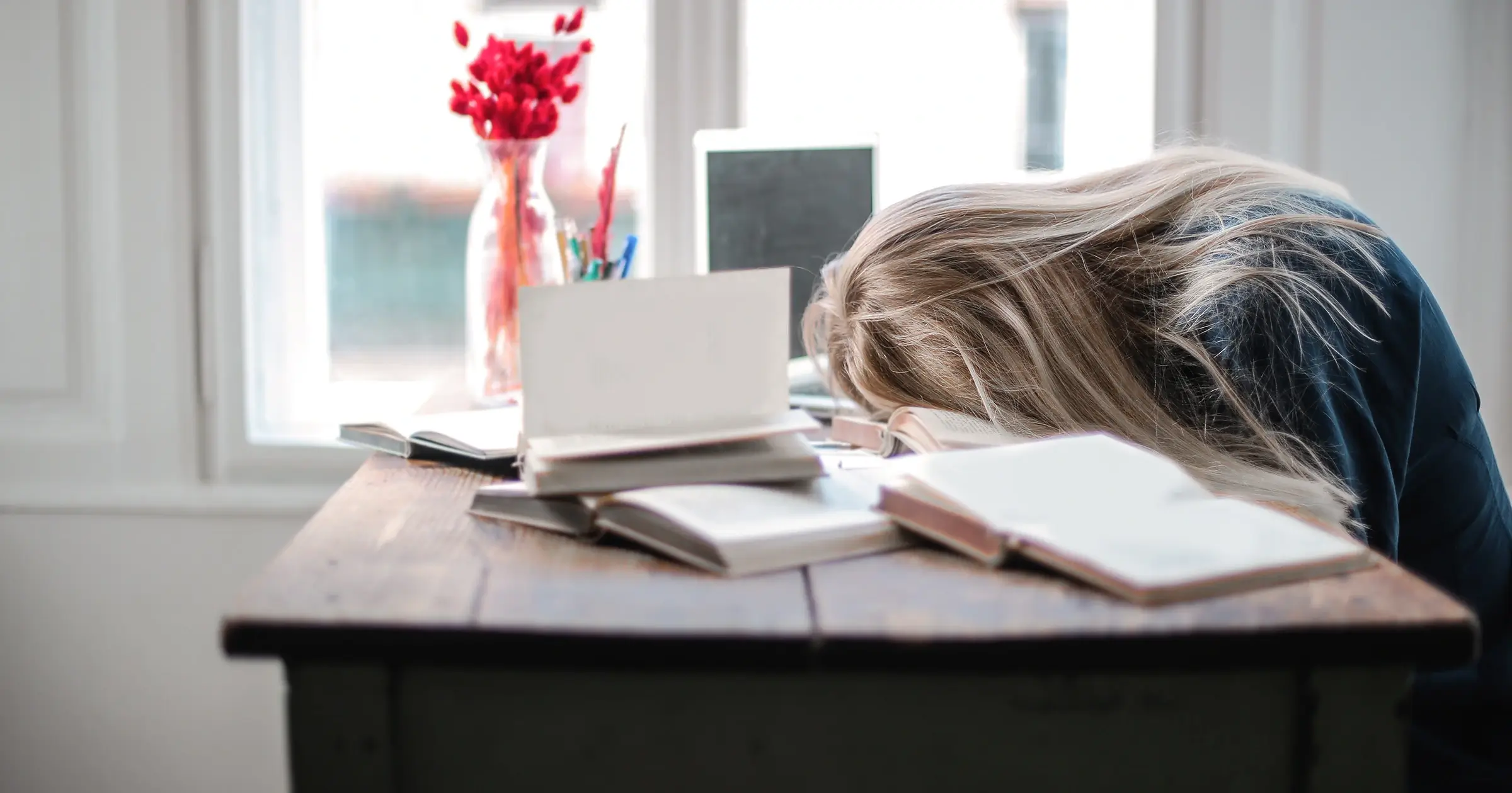 Tired woman sleeping at her desk