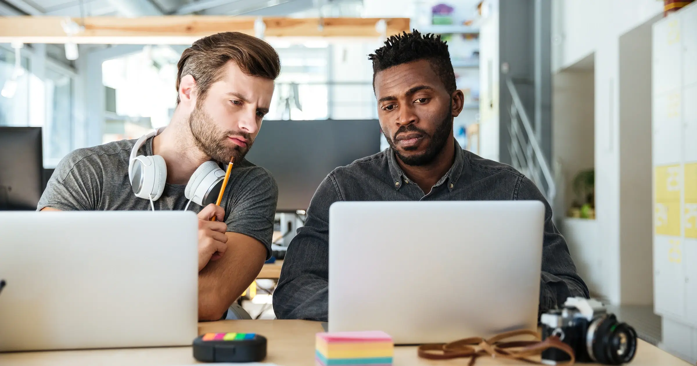 Two office workers on their laptops