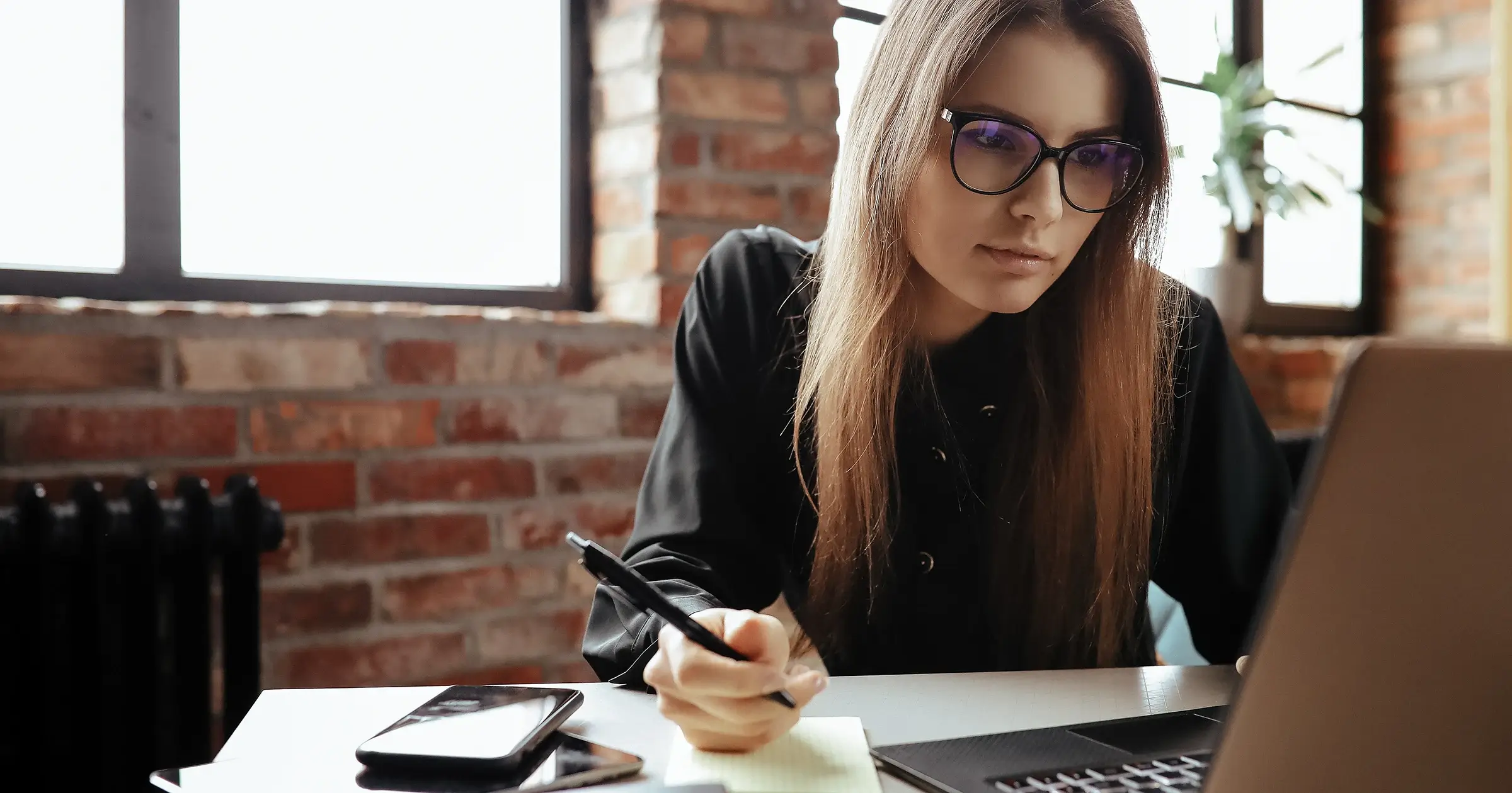 Girl with glasses working on laptop