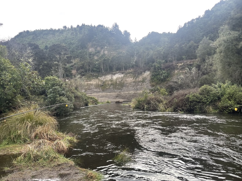 New Zealand fishing adventure amidst rugged coastal beauty.