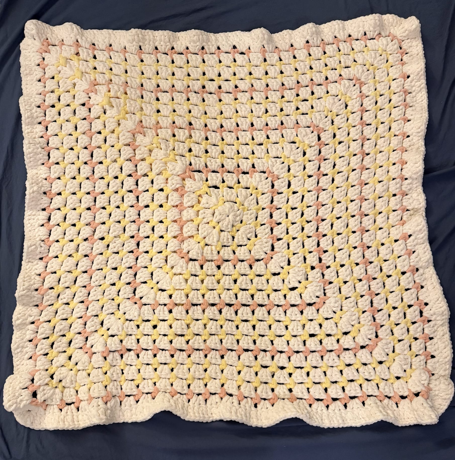 Soft pink and cream baby blanket with scalloped edges