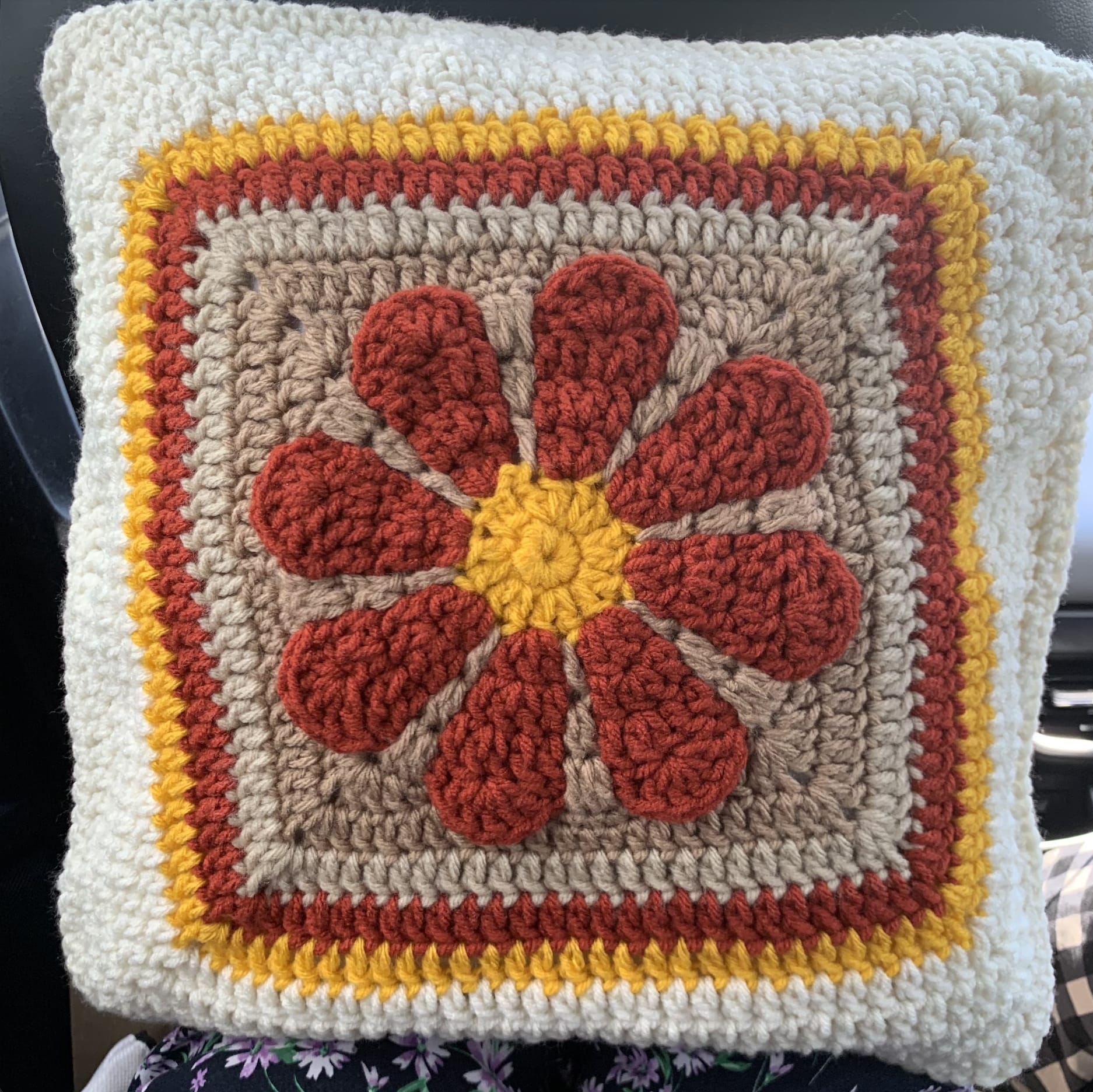 Retro daisy crochet pillow in rust and yellow