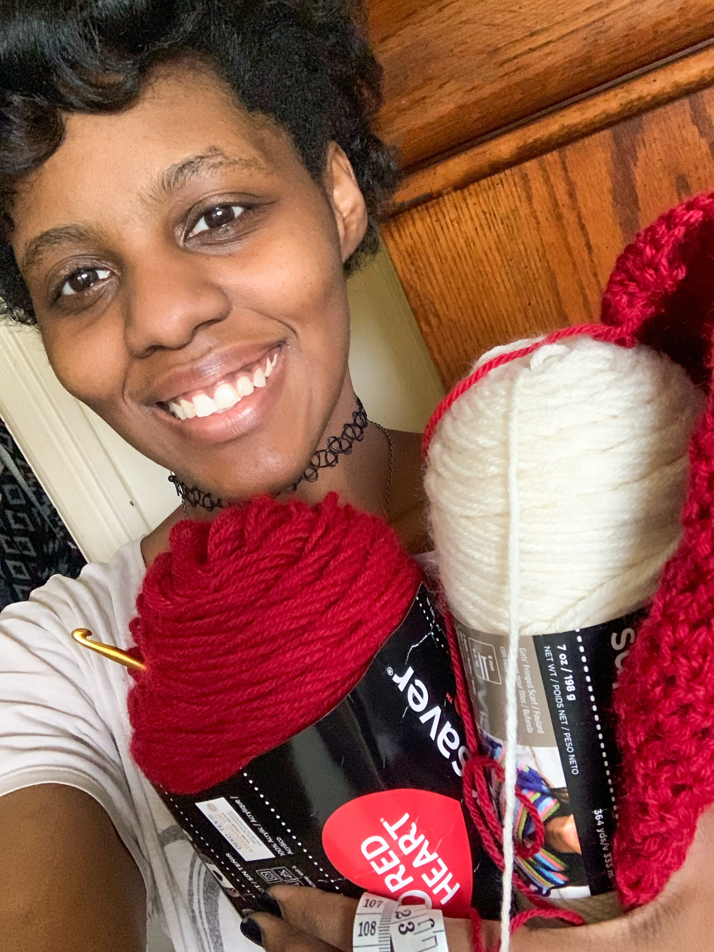 Selena, founder of Stitch Reflections, smiling with yarn and crochet hook