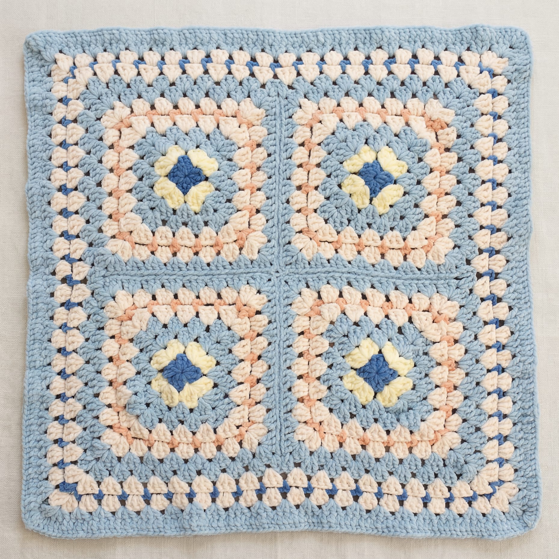 Blue baby blanket with floral granny squares