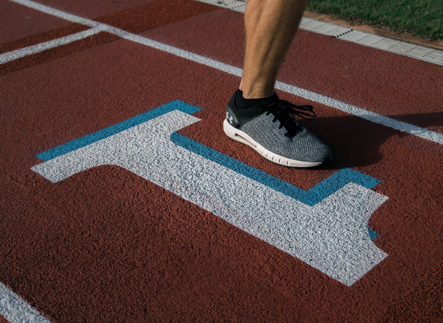Person Running Over the Mile Race Marker