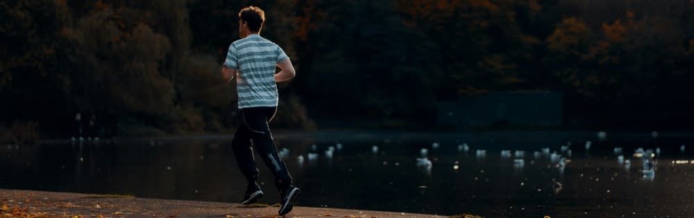 Man Running Near Lake
