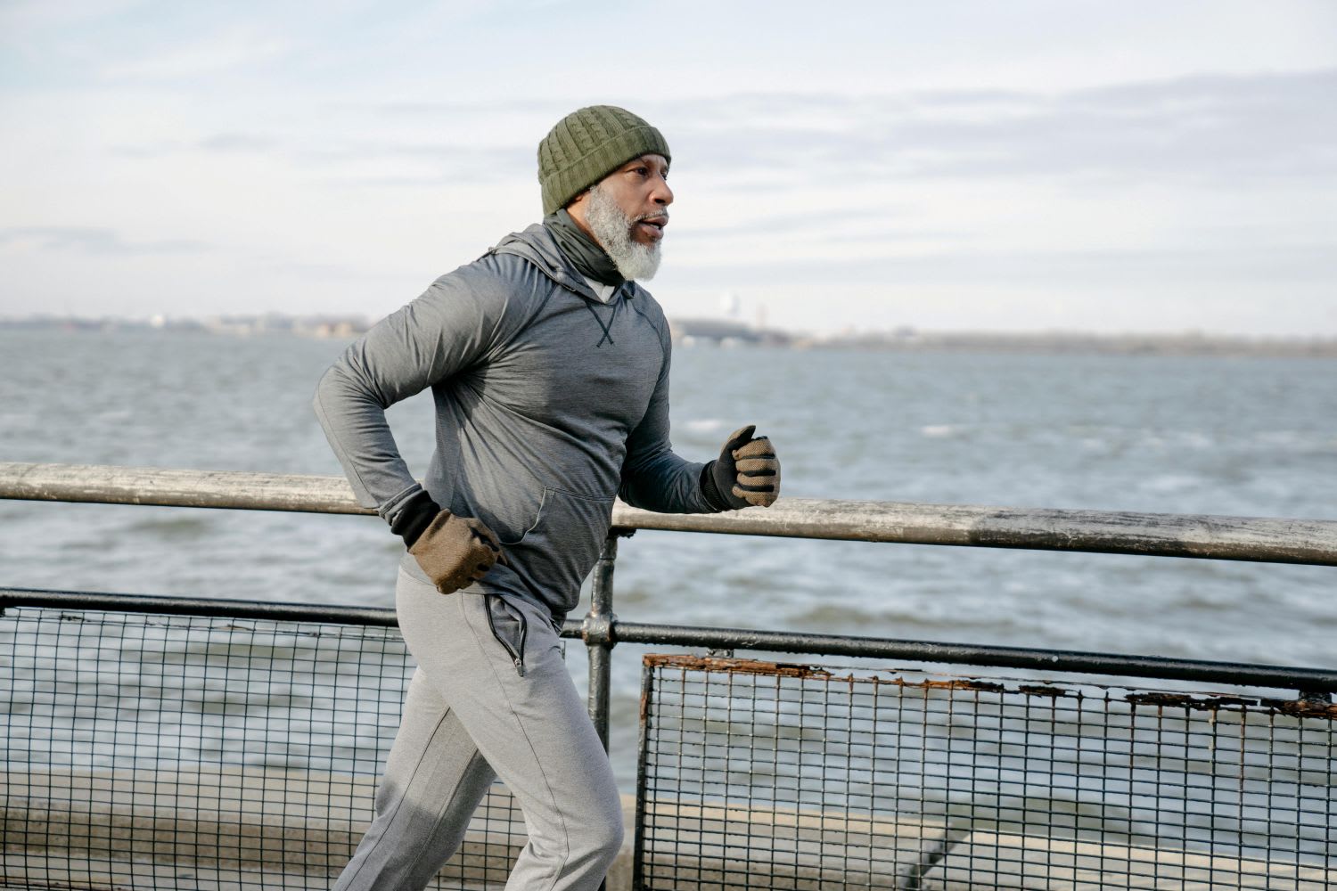 Man Running with Winter Gloves On