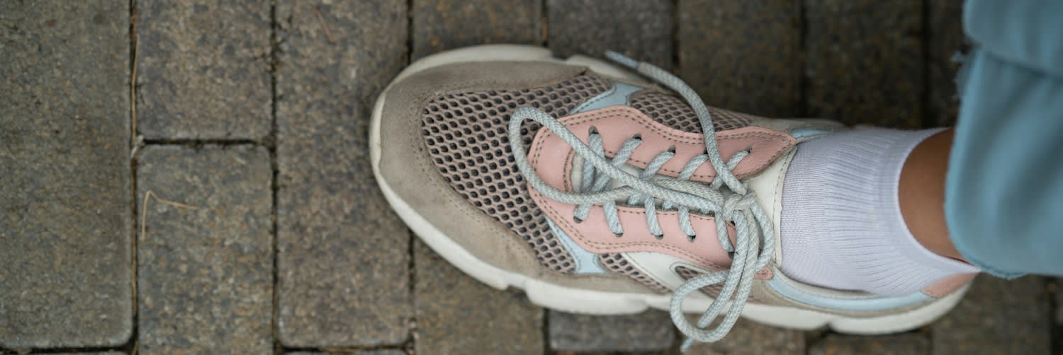 Pale Running Trainers on a Stone Floor