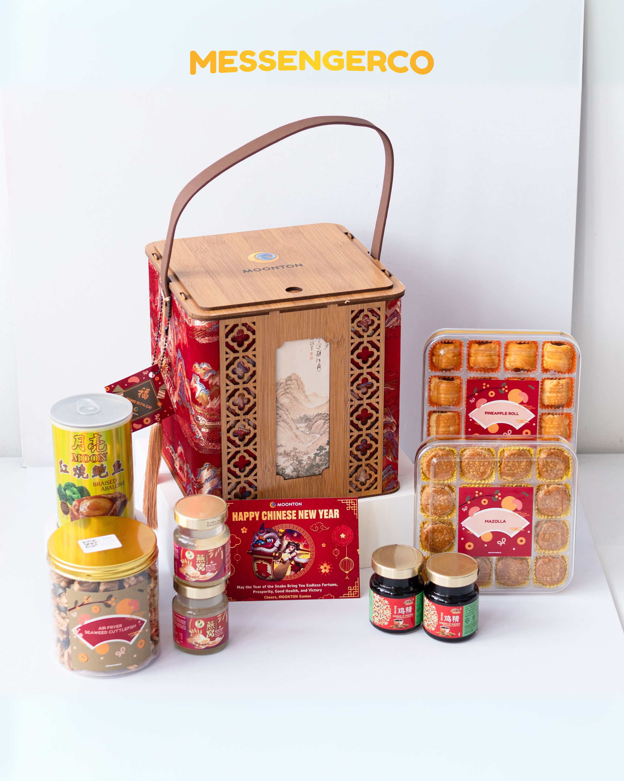 Premium CNY corporate hamper bamboo basket branded MOONTON, including pineapple tart trays, abalone tin, bird’s nest jars and seaweed snack.