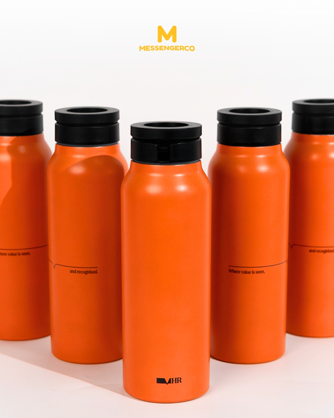 A vibrant orange thermos flask with a black lid featuring logo printing, from past projects, ideal for branding promotion.