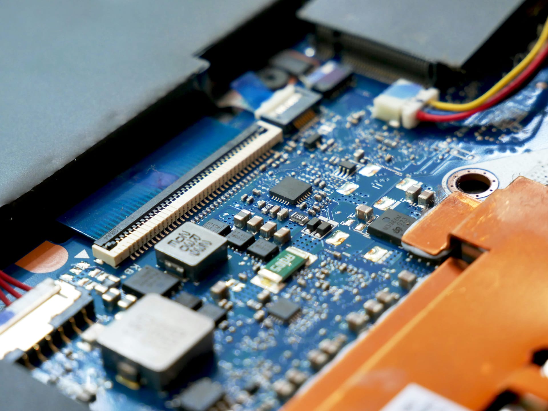 Close-up of a blue printed circuit board with microchips