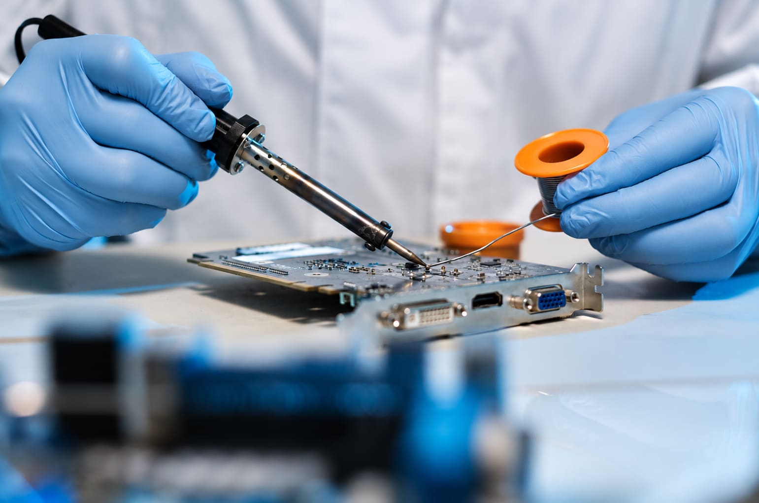 Technician soldering components on a circuit board