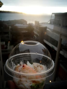 Snacking on some fresh crab meat. Grab your seafood of choice at the market and enjoy it with views of the water for a fraction of restaurant costs.