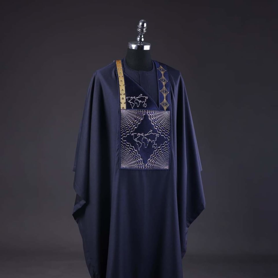 Navy agbada with a silver embroidered chest panel and gold trim, displayed on a mannequin