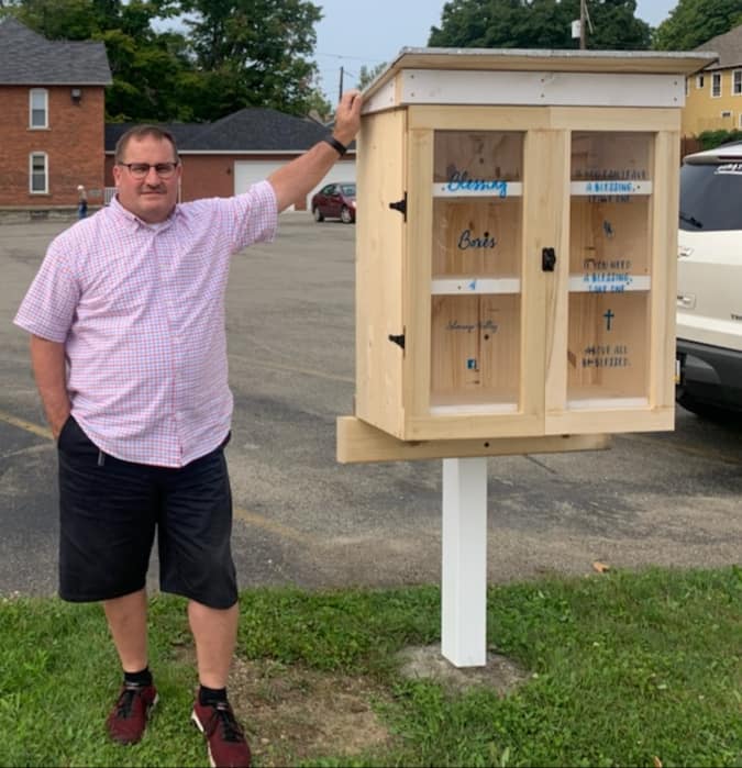 Pastor Jeff Landfried standing next to the Blessing Box outside.