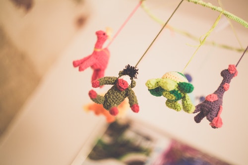 A baby carousel above a crib