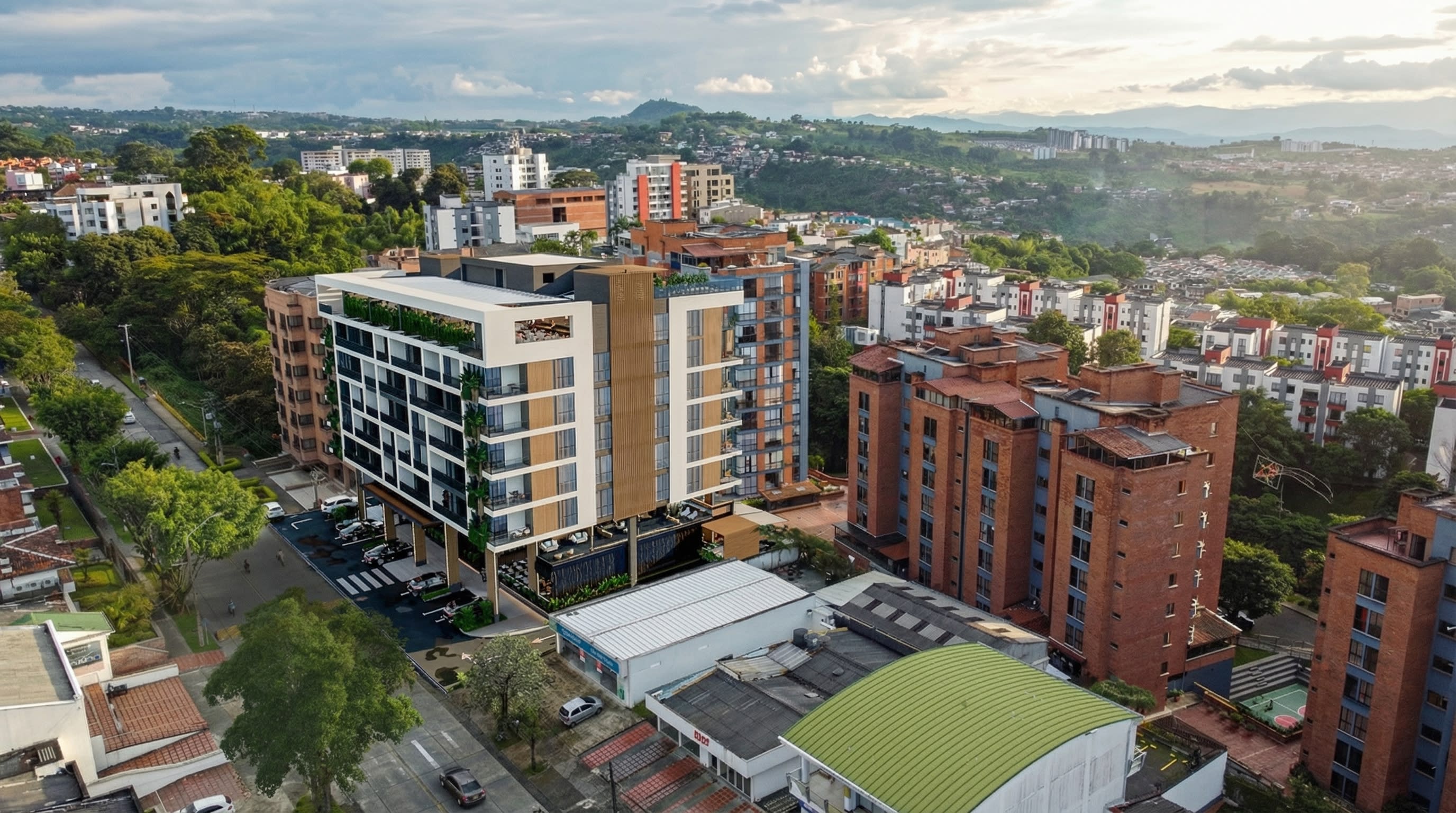 Vista aérea diurna de Volterra Plaza Suites y su entorno urbano en Álamos, Pereira.