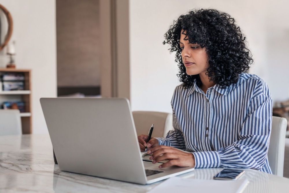 woman at a table on a laptop